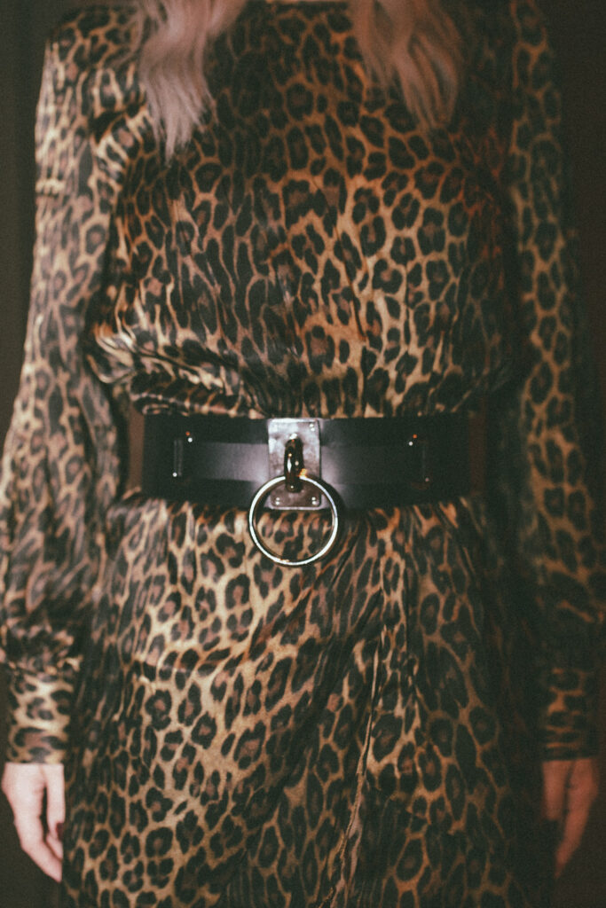 A close up of Trina's leopard dress and leather o-ring belt from Zana Bayne
